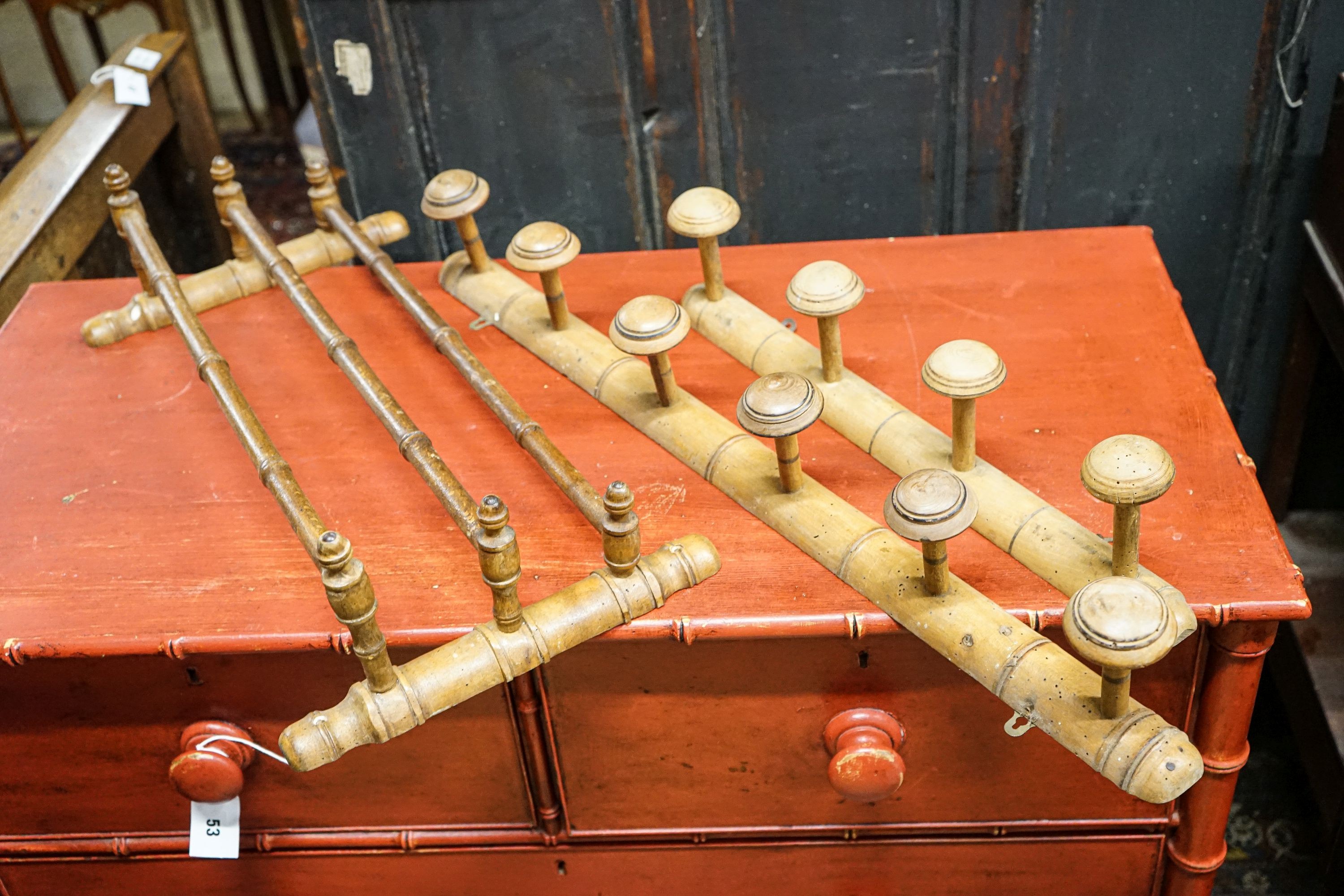 Six assorted treen measures and butter pails, a pair of pricket candlesticks, height 37cm and three faux bamboo coat hooks